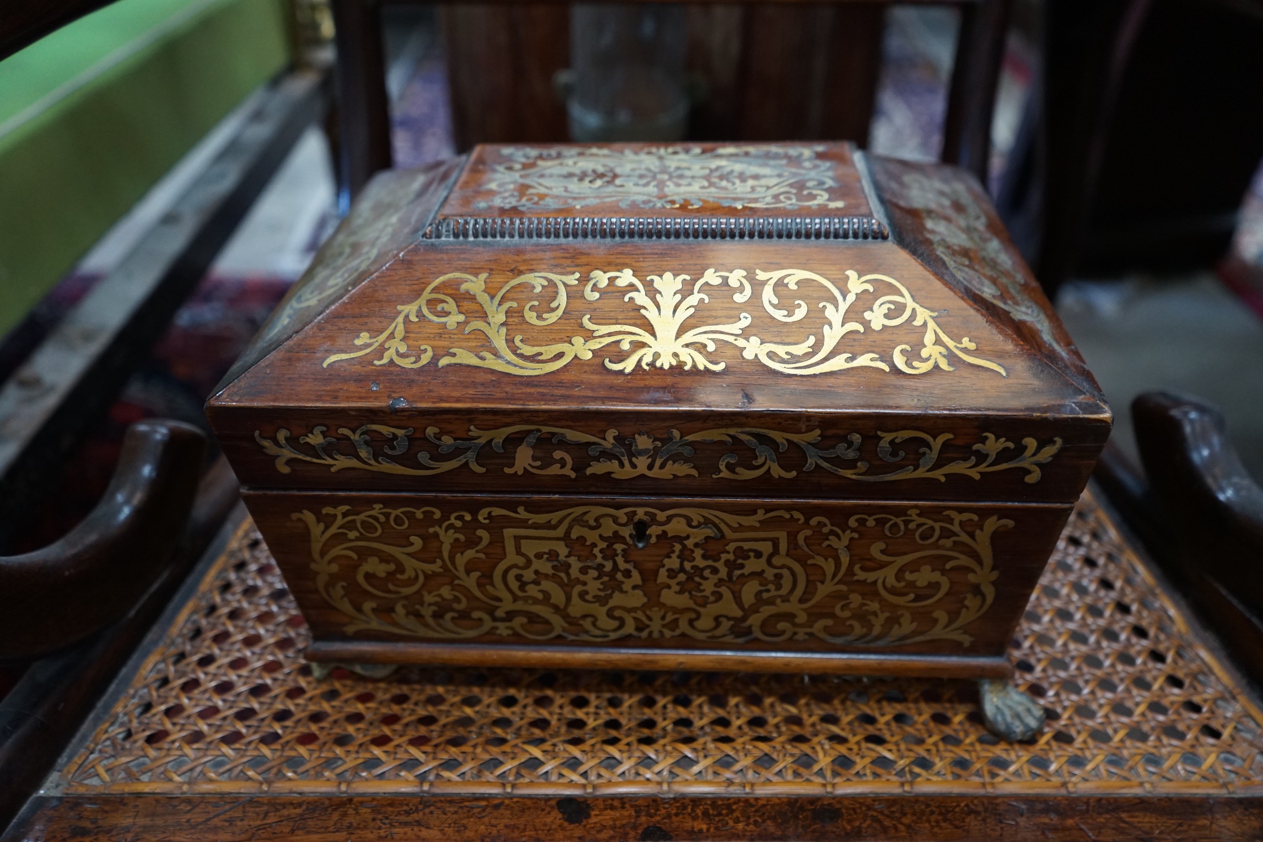 A Regency brass inlaid rosewood cane seat elbow chair together with a Regency brass inlaid work box